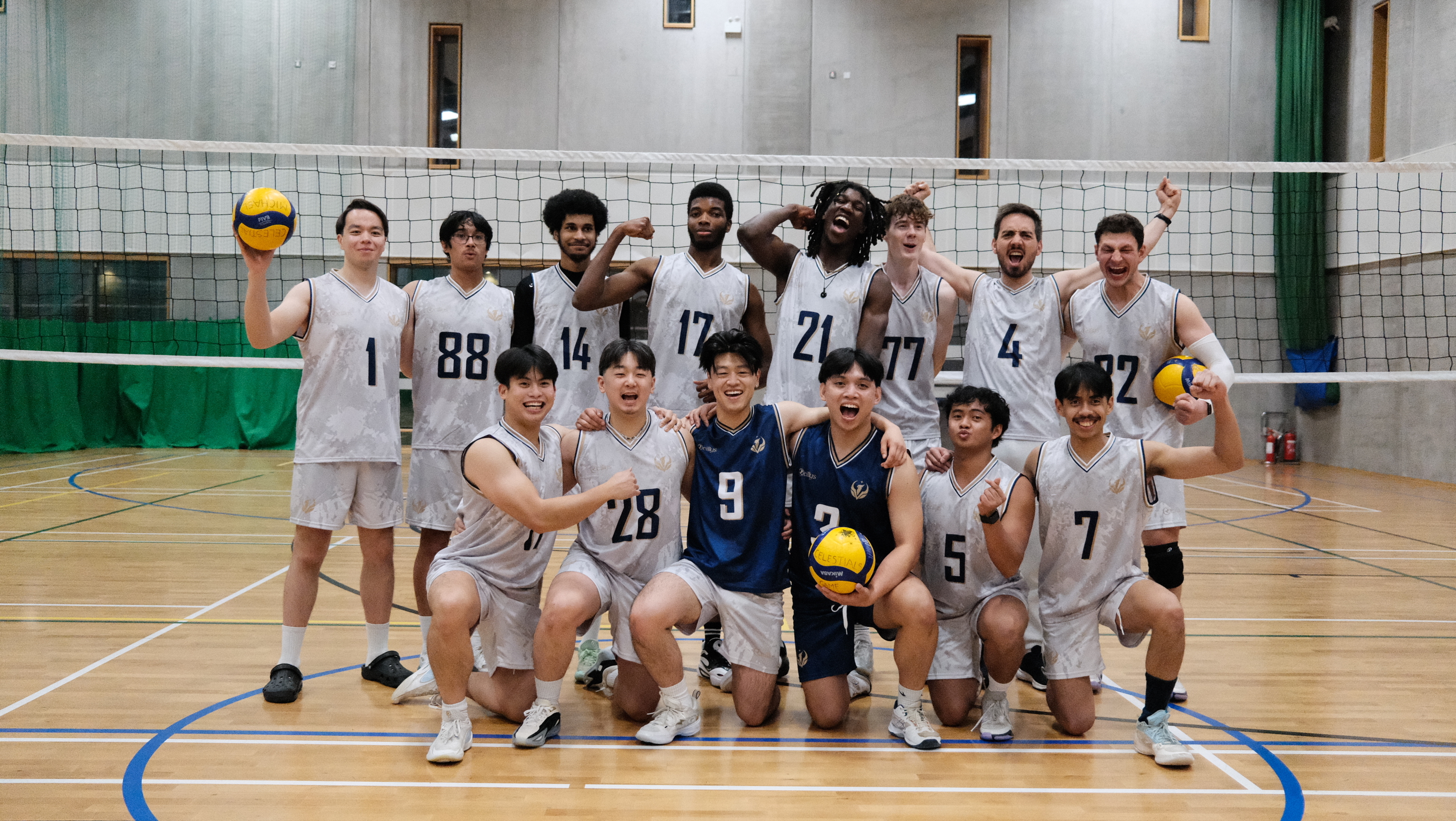 Celestials Men’s Division 3 squad together on the volleyball court in their white and navy kits.